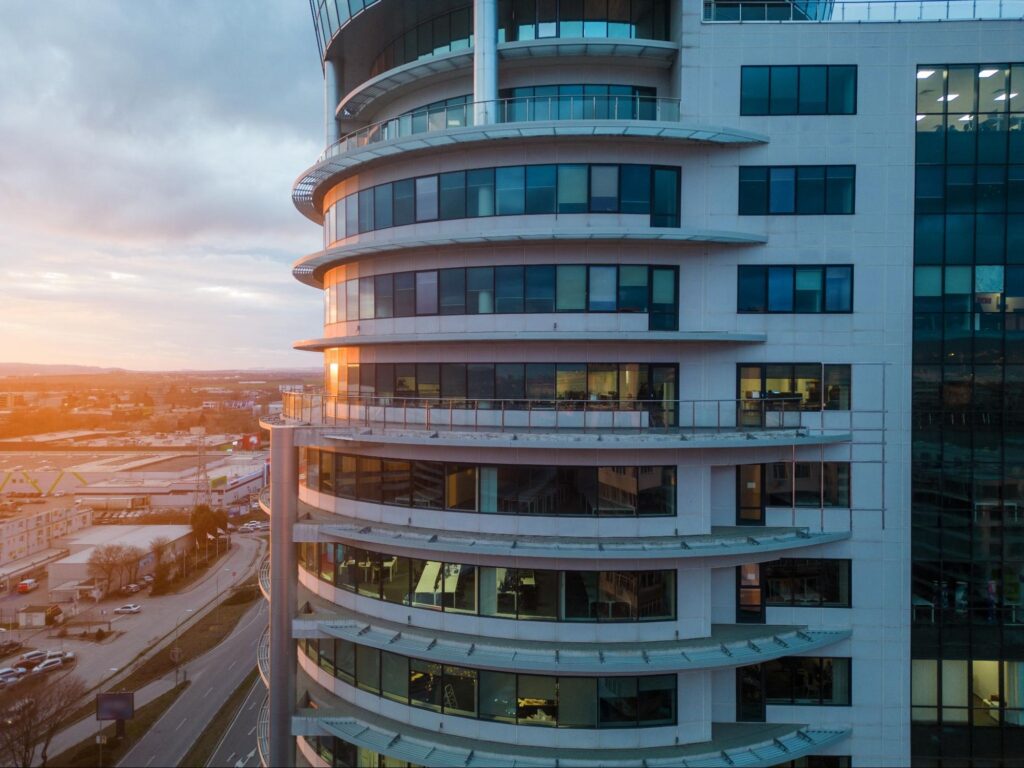 Commercial skyscraper with a city skyline backdrop