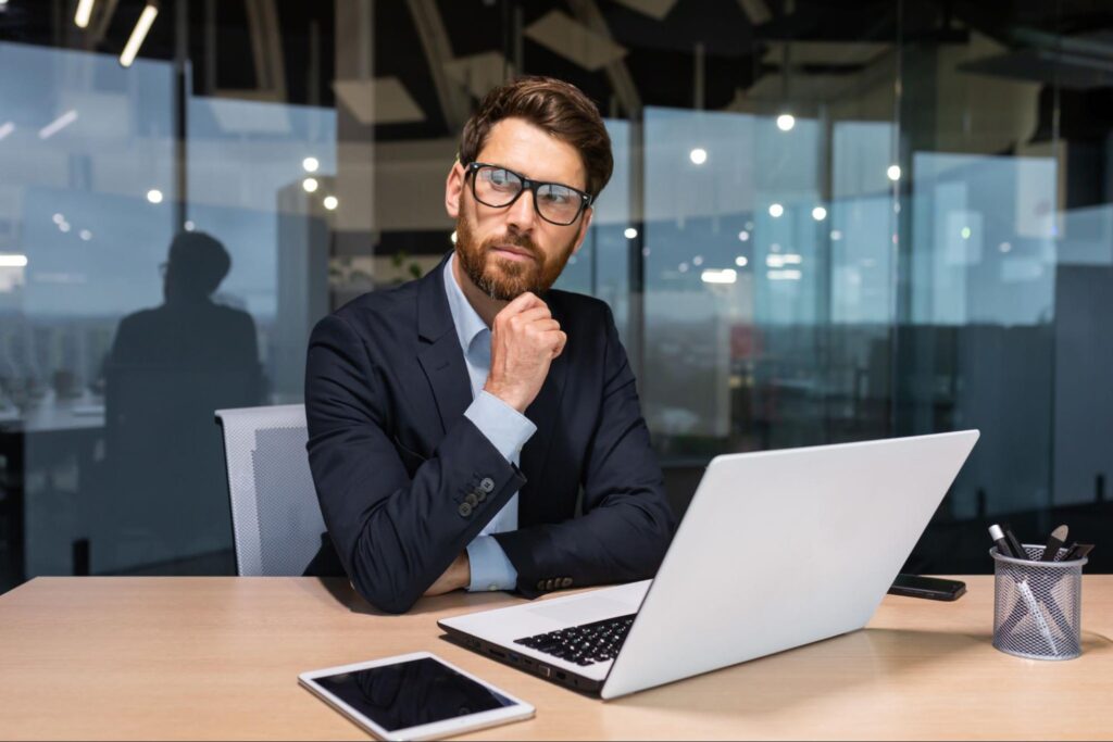 Professional evaluating lease abstracts on a laptop, showcasing the role of accurate lease management in commercial real estate.