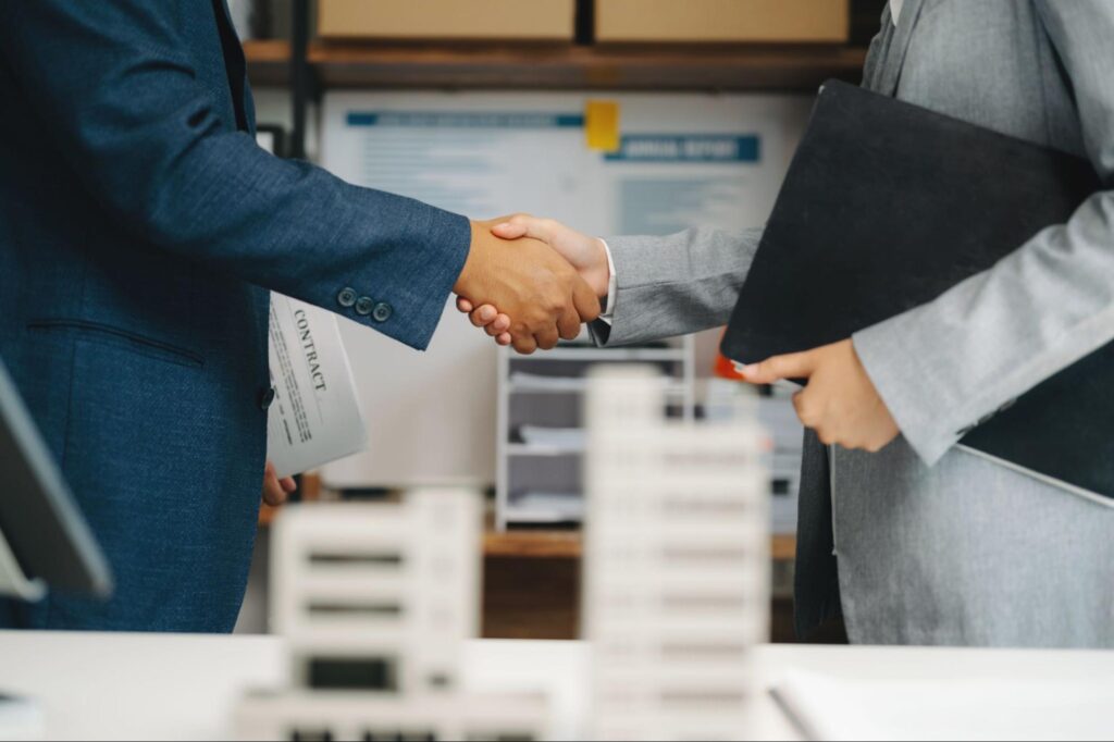 Handshake between two corporate professionals inside an office