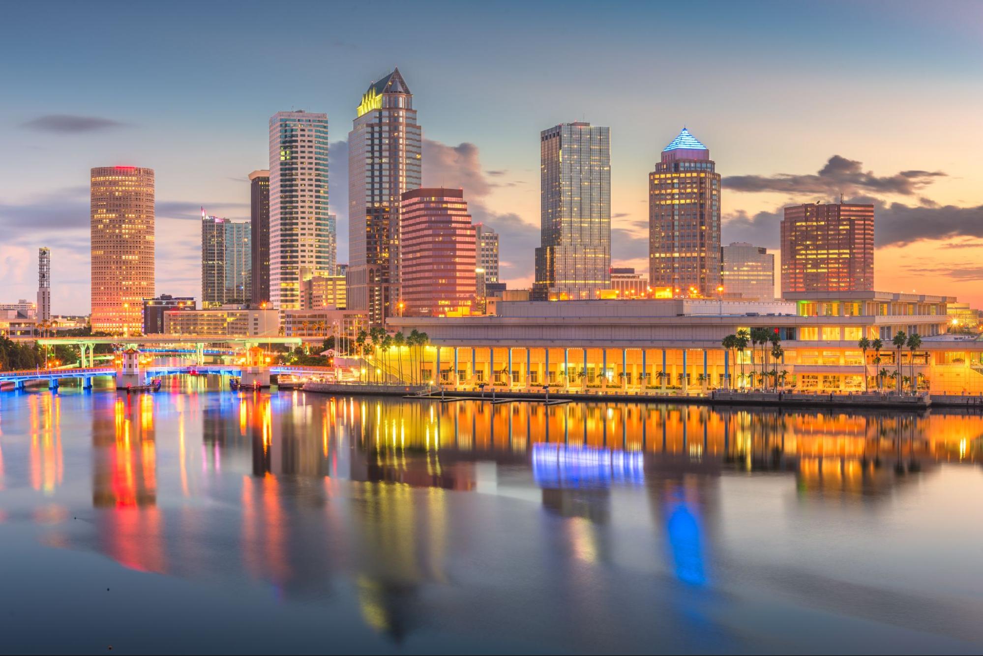 Tampa skyline featuring skyscrapers near the water during twilight