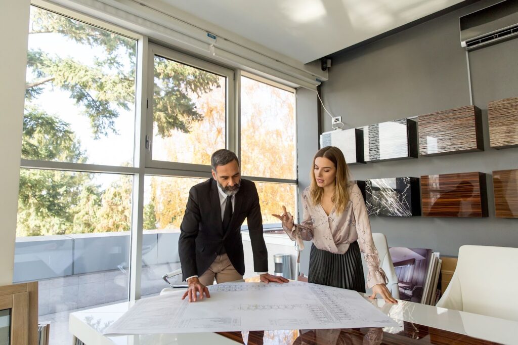 Real estate agent explaining Saint Petersburg property trends to an investor in an office setting