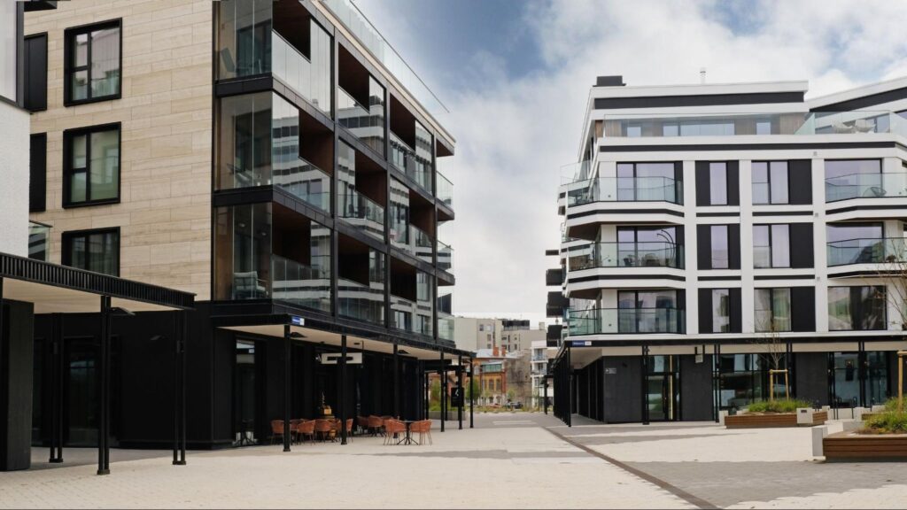 Modern mixed-use development featuring retail spaces below and residential apartments above