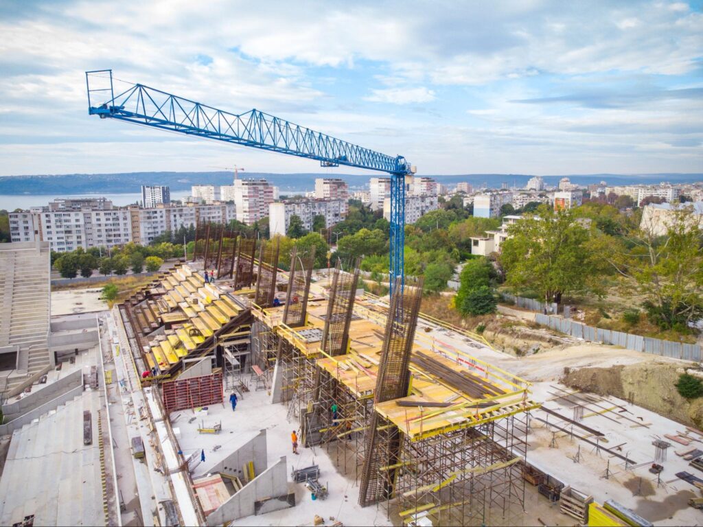 Ongoing industrial development in Thonotosassa, with cranes and workers constructing a new warehouse facility