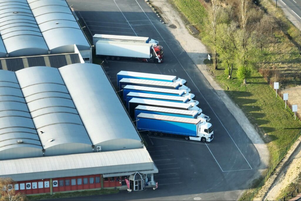 An industrial warehouse in Land O' Lakes, Florida, with trucking activity, emphasizing the area's strategic location for logistics and distribution.