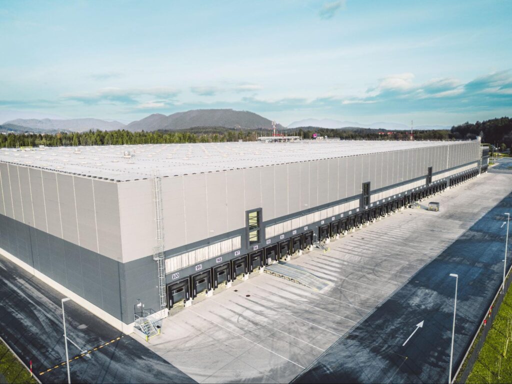 Expansive warehouse facility in Land O' Lakes with ample parking space, showcasing the area's rising demand for industrial and commercial real estate investments.