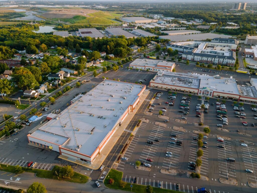 A modern shopping plaza in Land O' Lakes, Florida, with retail stores and parking space, demonstrating the area's thriving commercial sector.