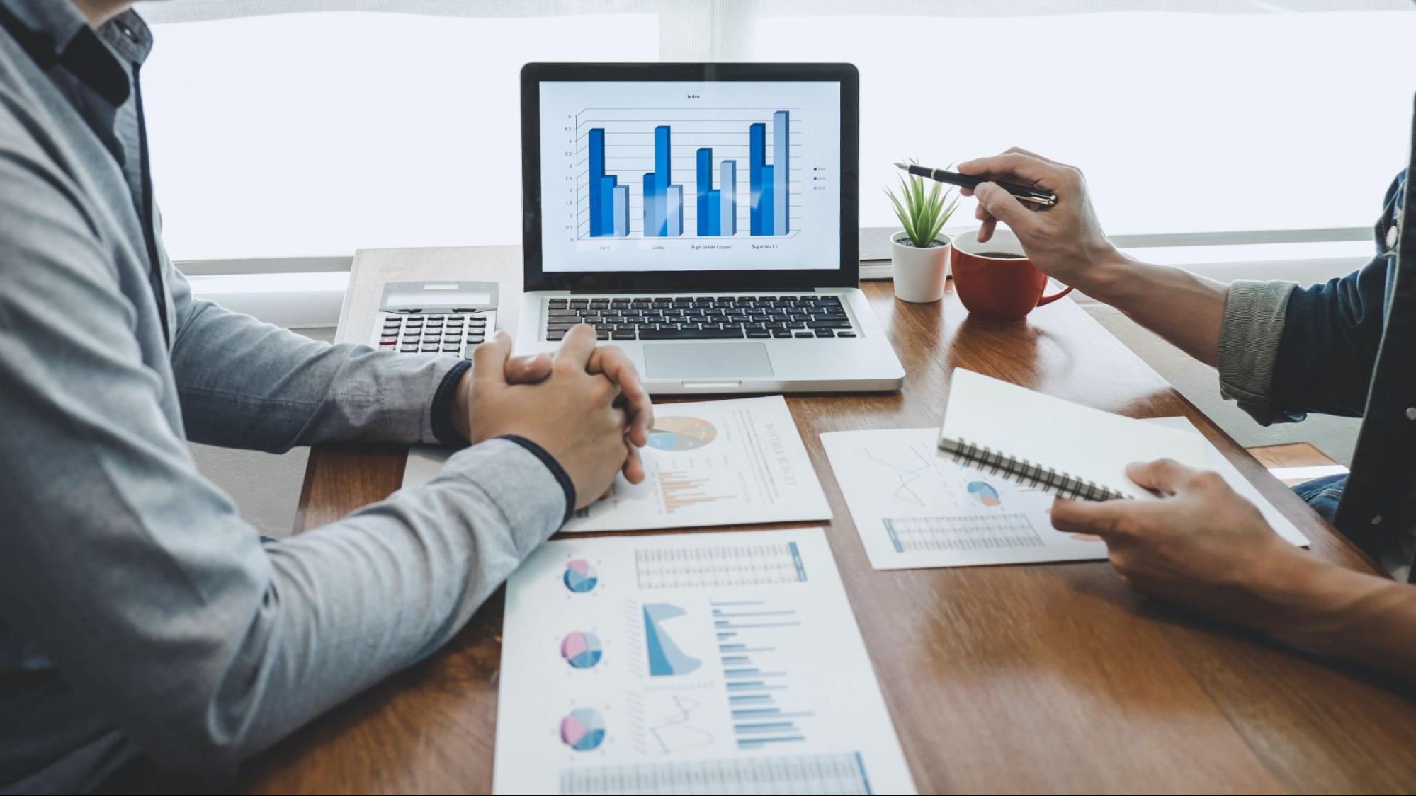 Real estate professionals analyzing mixed-use development plans in a modern office.